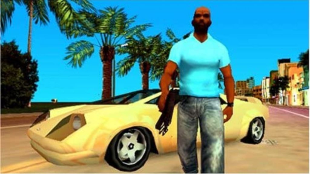 Declaración de la misión de nuestro artículo de noticias sobre la emulación de PSP.  Presenta una captura de pantalla de Vice City Stories de un personaje parado frente a un automóvil con un arma en la mano.